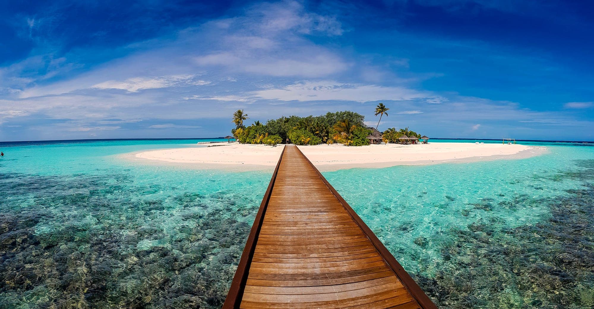 Overwater villas above a calm tropical lagoon