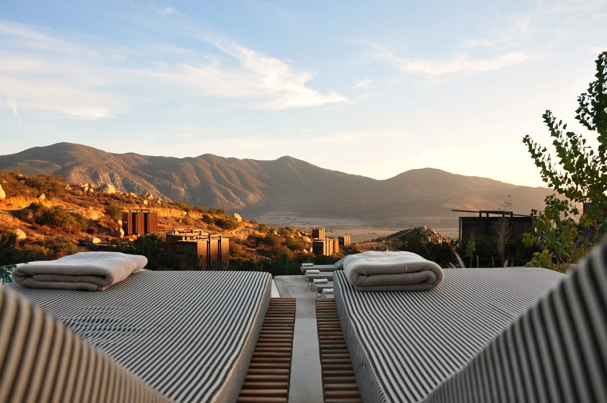 Sun loungers on a resort terrace with mountains beyond