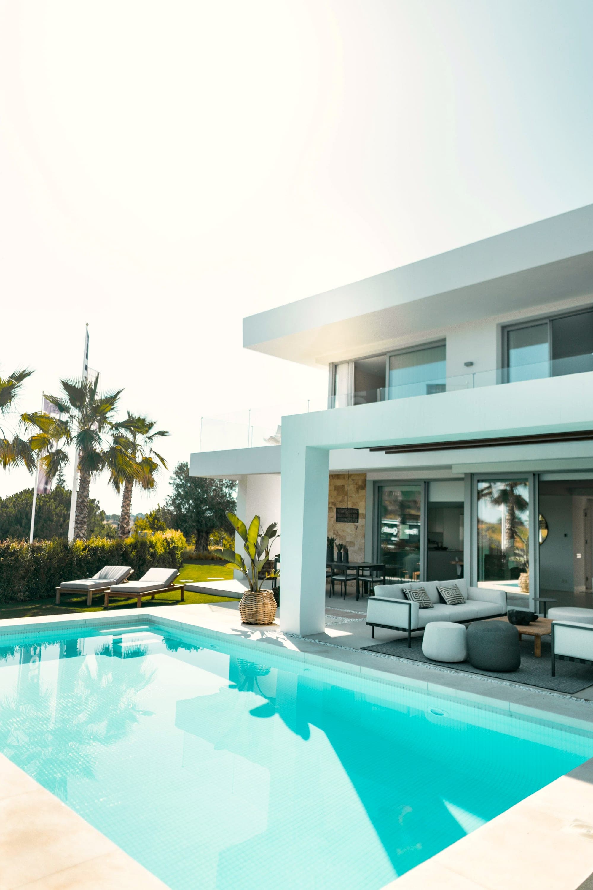 A private villa with a shimmering pool under a clear sky